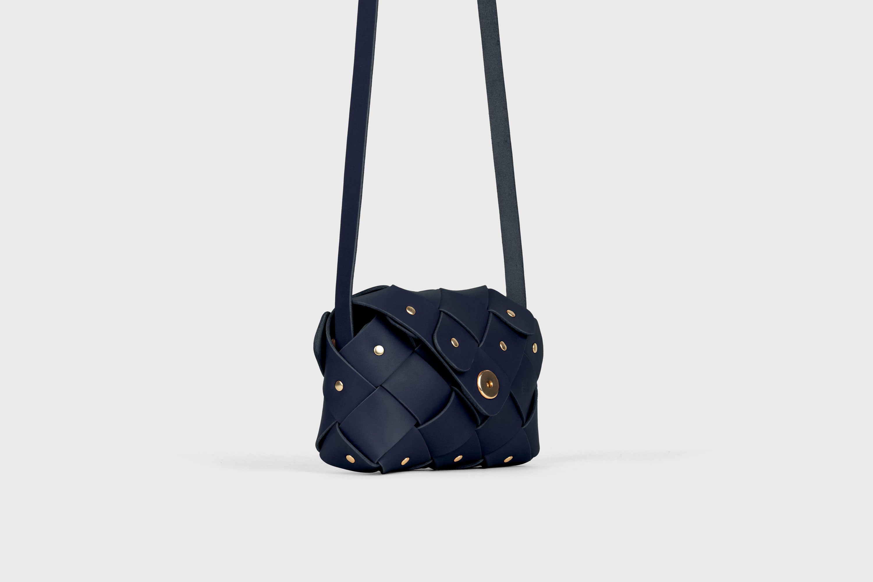 Pine Flap Bag Small In Marine Blue Color In Vegetable Tanned Leather Architectural Structure With Rivets Atelier Madre Manuel Dreesmann Barcelona Spain