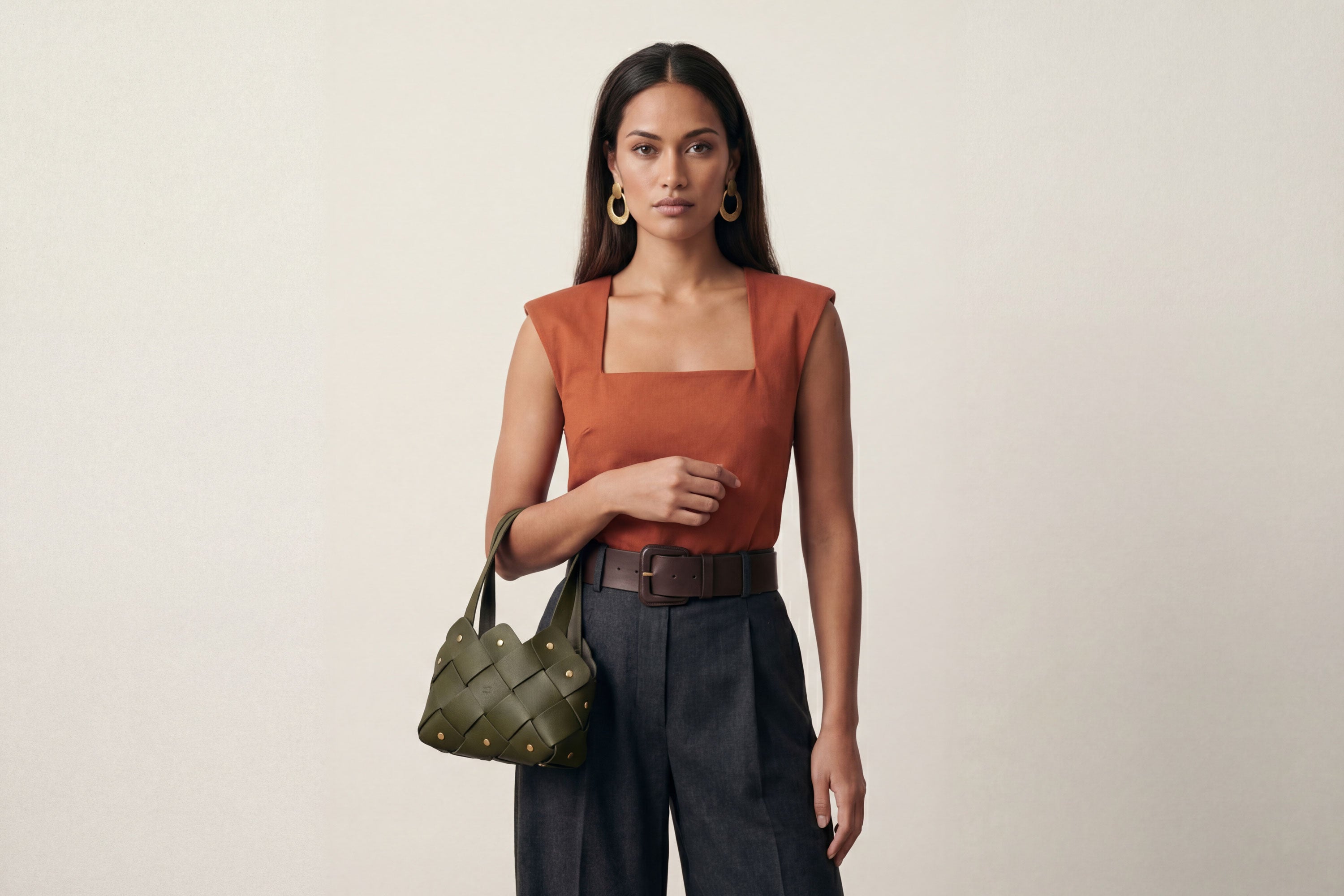 Pine Mini Tote Bag In Olive Green Color In Vegetable Tanned Leather On Woman Model Woven Technique and Brass Rivets Atelier Madre Manuel Dreesmann Barcelona Spain