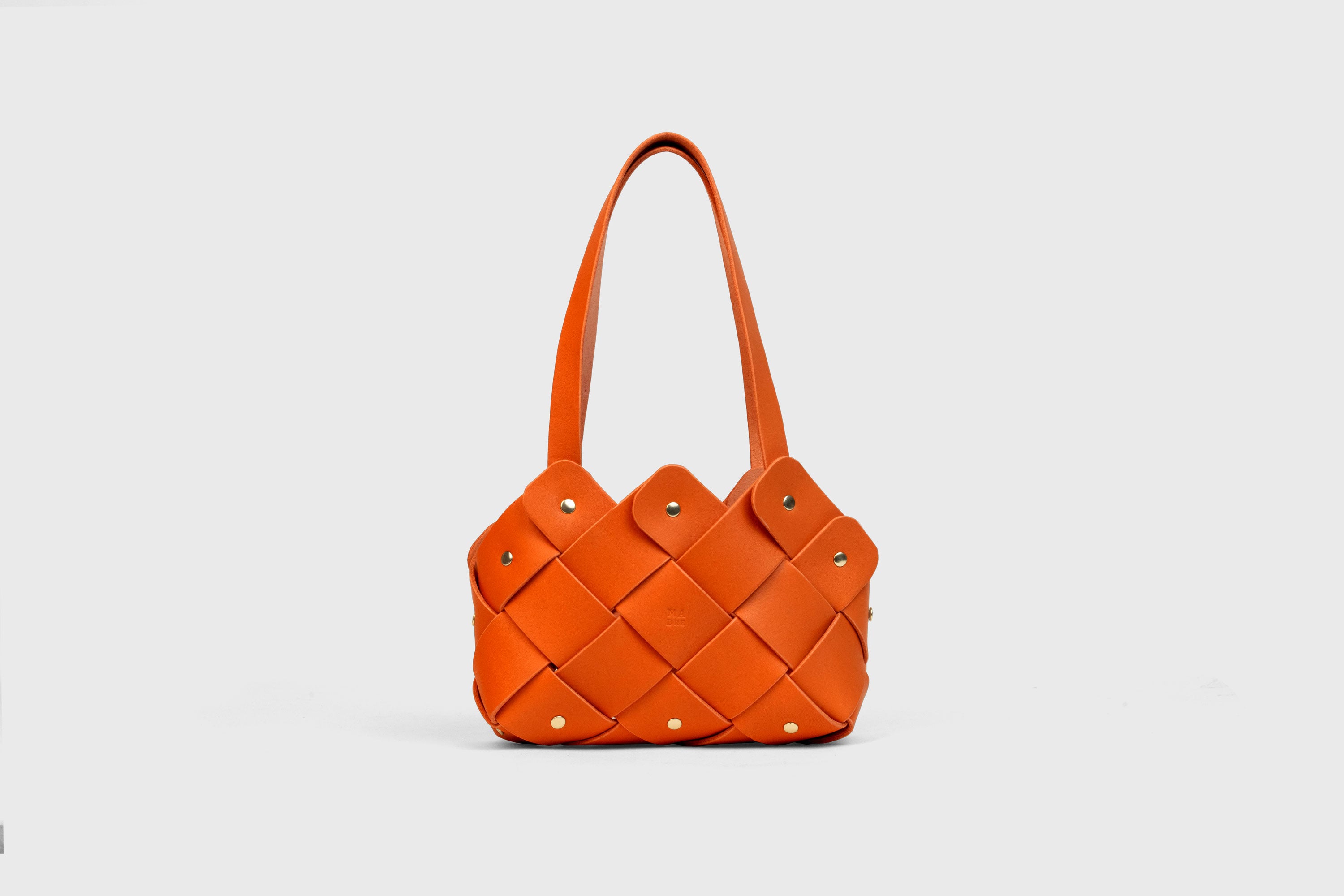 Pine Mini Tote Bag In Orange Color In Vegetable Tanned Leather Woven Technique and Brass Rivets Atelier Madre Manuel Dreesmann Barcelona Spain