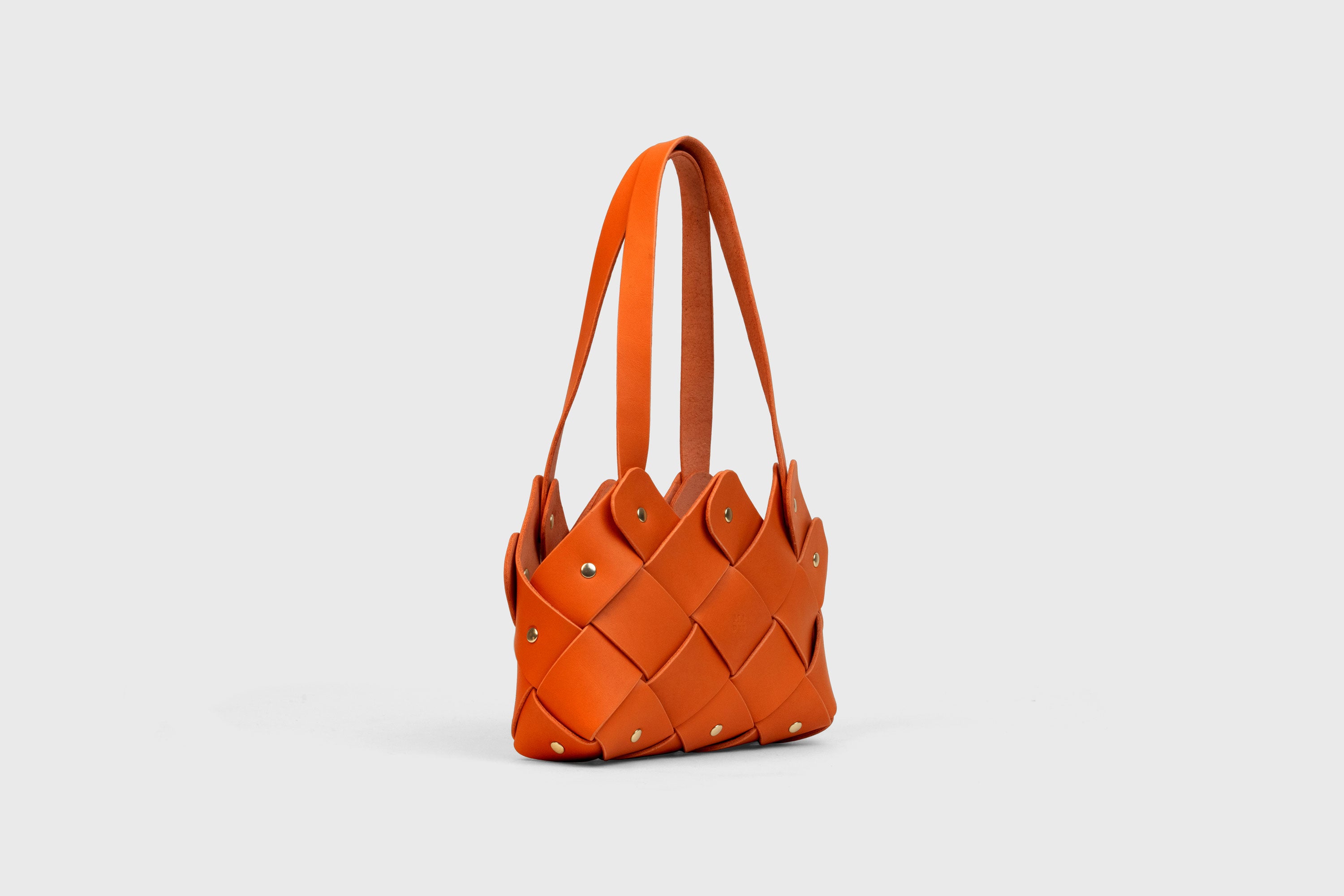Pine Mini Tote Bag In Orange Color In Vegetable Tanned Leather Woven Technique and Brass Rivets Atelier Madre Manuel Dreesmann Barcelona Spain