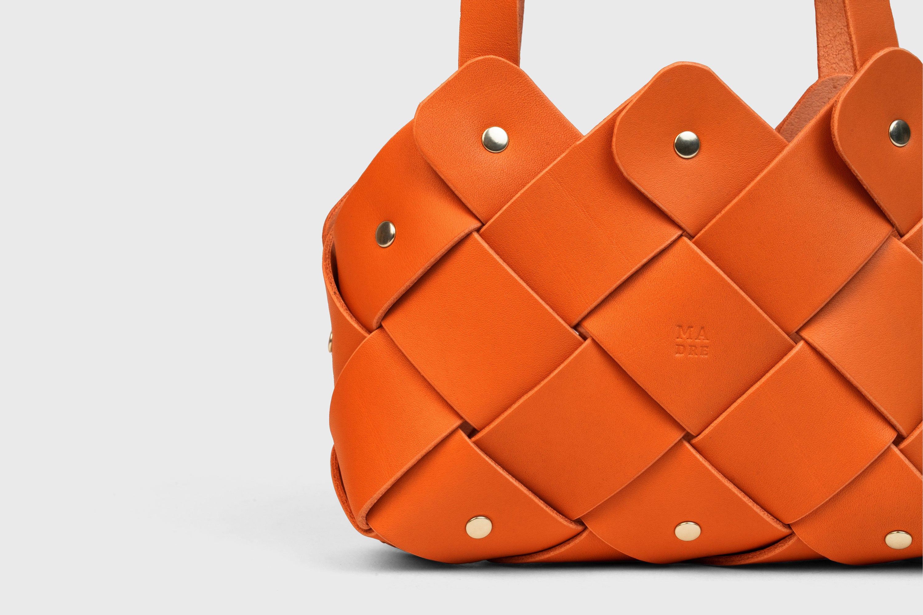 Pine Mini Tote Bag In Orange Color In Vegetable Tanned Leather Woven Technique and Brass Rivets Atelier Madre Manuel Dreesmann Barcelona Spain