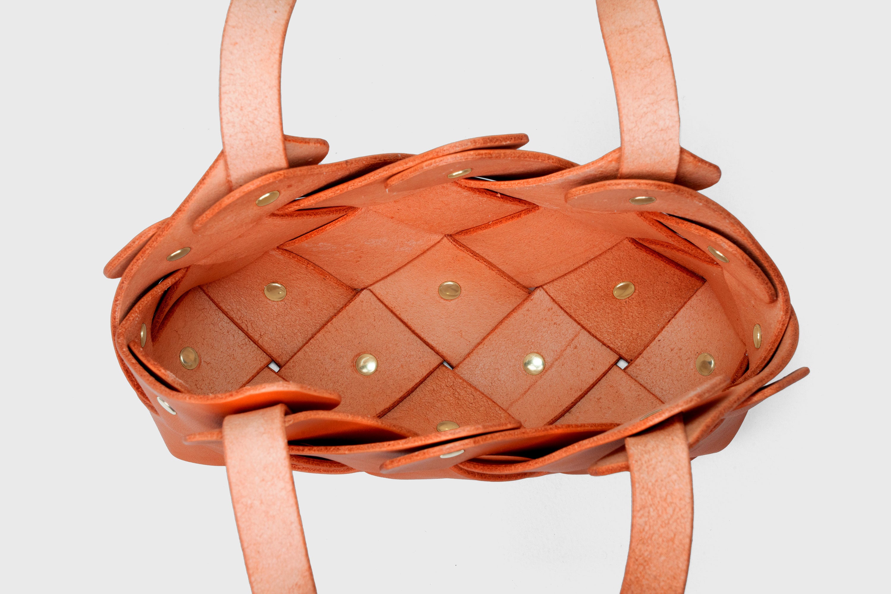 Pine Mini Tote Bag In Orange Color In Vegetable Tanned Leather Woven Technique and Brass Rivets Atelier Madre Manuel Dreesmann Barcelona Spain