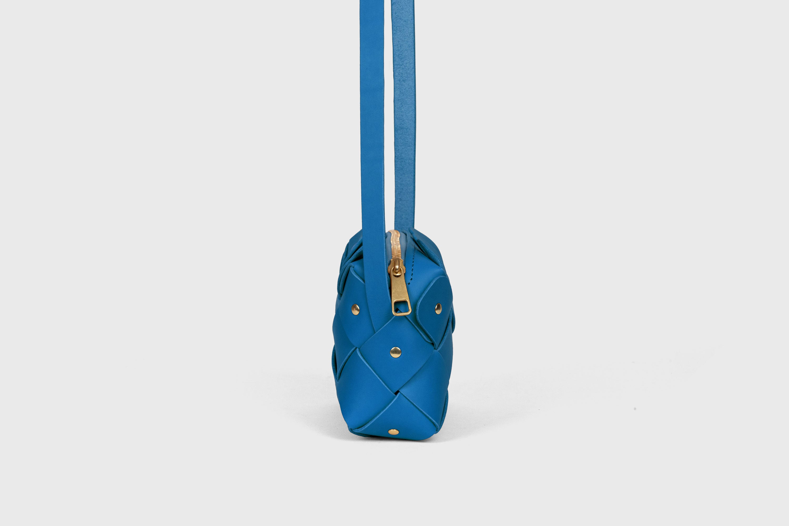 Pine Mini Zipper Bag in Royal Blue Color In Vegetable Tanned Leather Unique Design Brass RIvets Atelier Madre Manuel Dreesmann Barcelona Spain