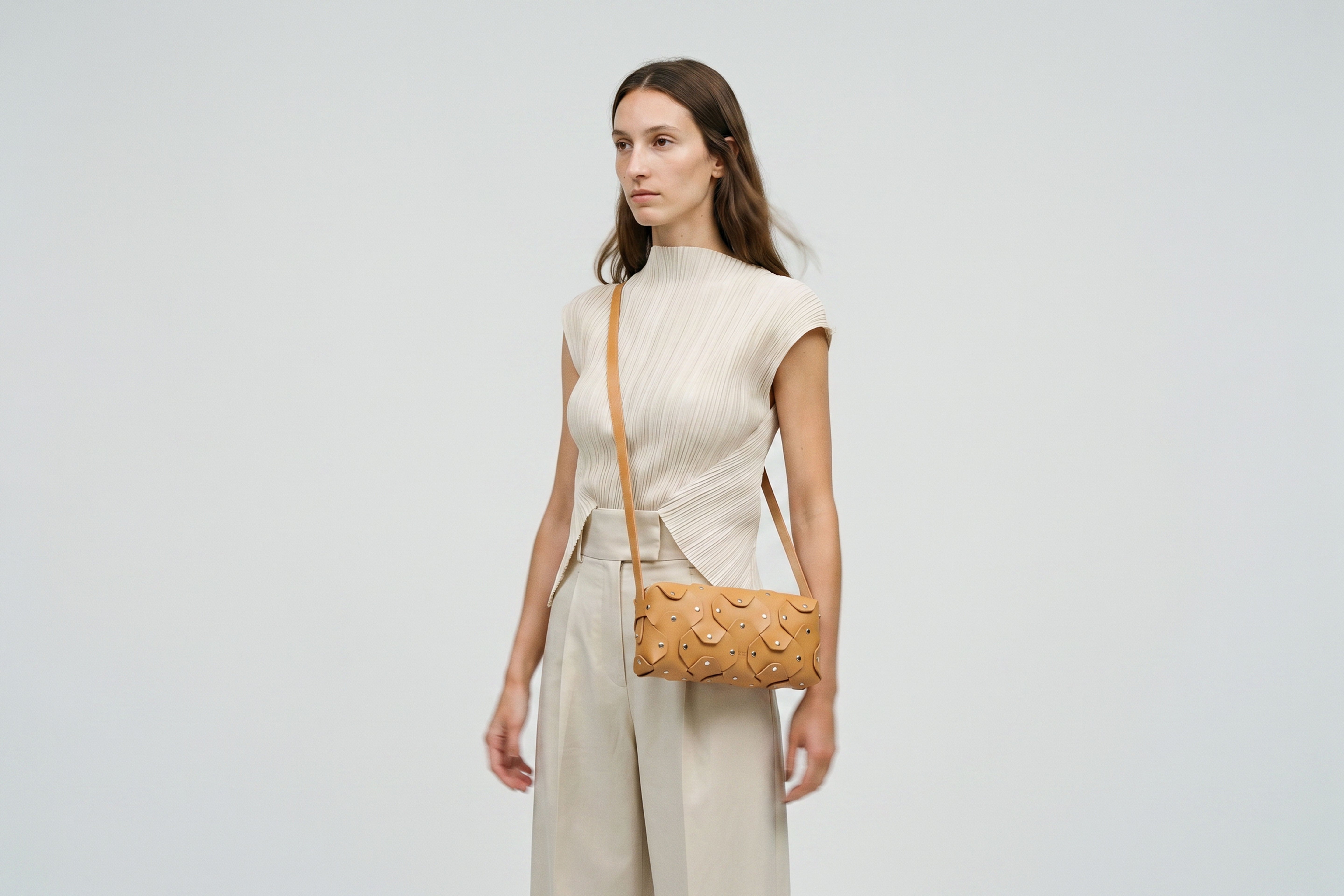 Rivet Bag 01 In Brown Color On A Woman Model In Vegetable Tanned Leather With Brass Rivets Unique Design Atelier Madre Manuel Dreesmann Barcelona Spain
