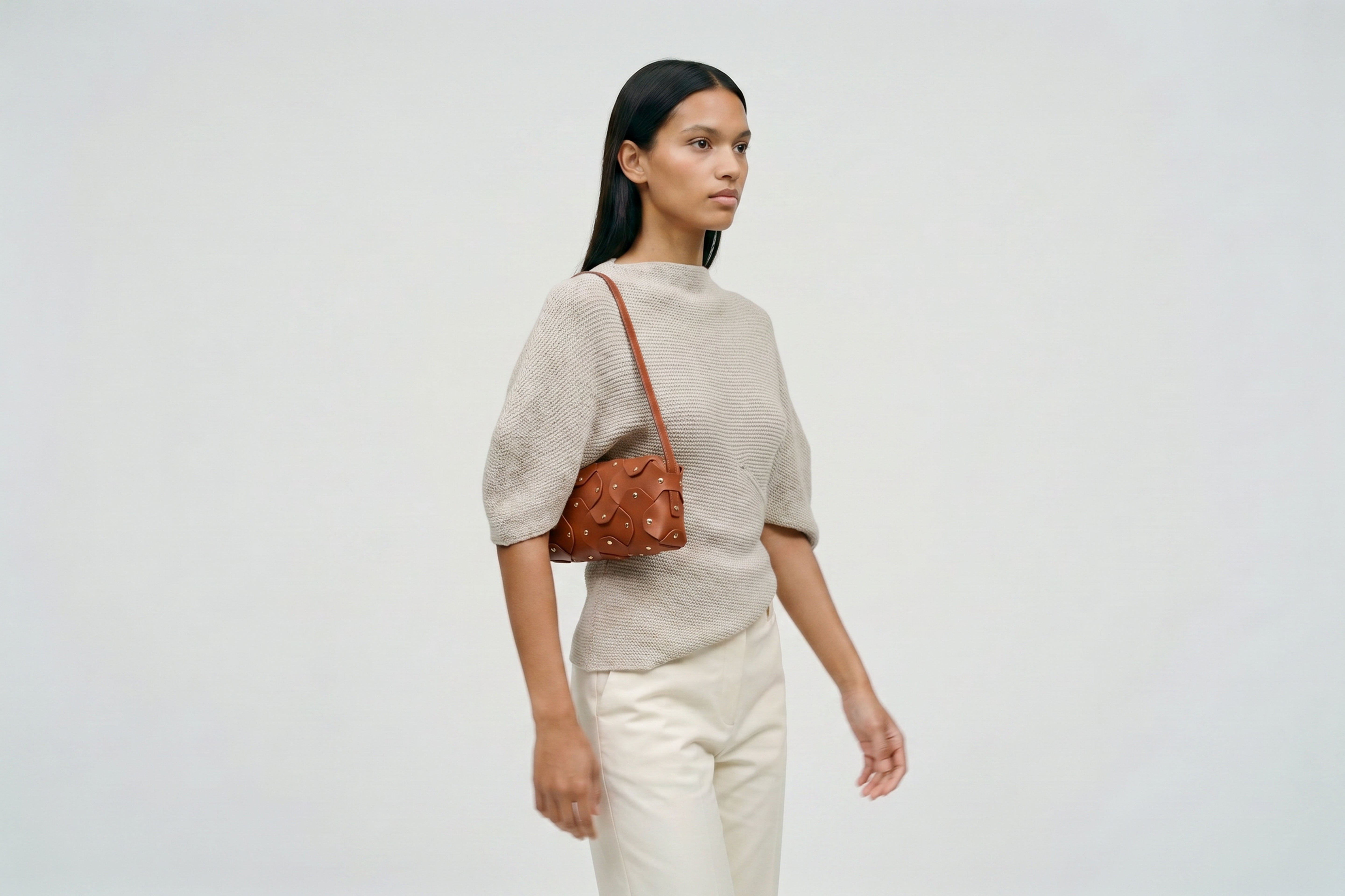 Rivet Bag 01 In Dark Brown Color On A Woman Model In Vegetable Tanned Leather With Brass Rivets Unique Design Atelier Madre Manuel Dreesmann Barcelona Spain