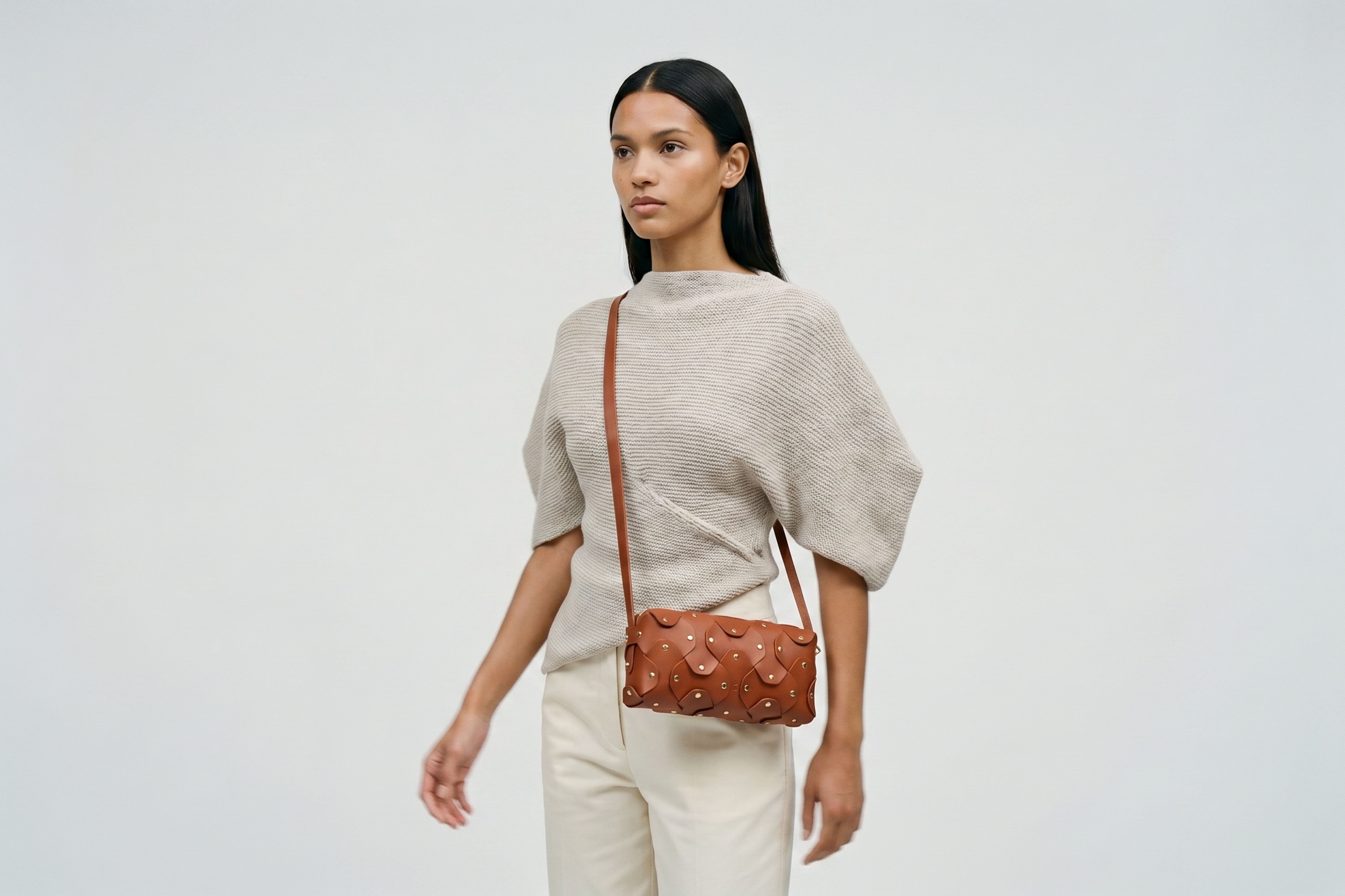 Rivet Bag 01 In Dark Brown Color On A Woman Model In Vegetable Tanned Leather With Brass Rivets Unique Design Atelier Madre Manuel Dreesmann Barcelona Spain
