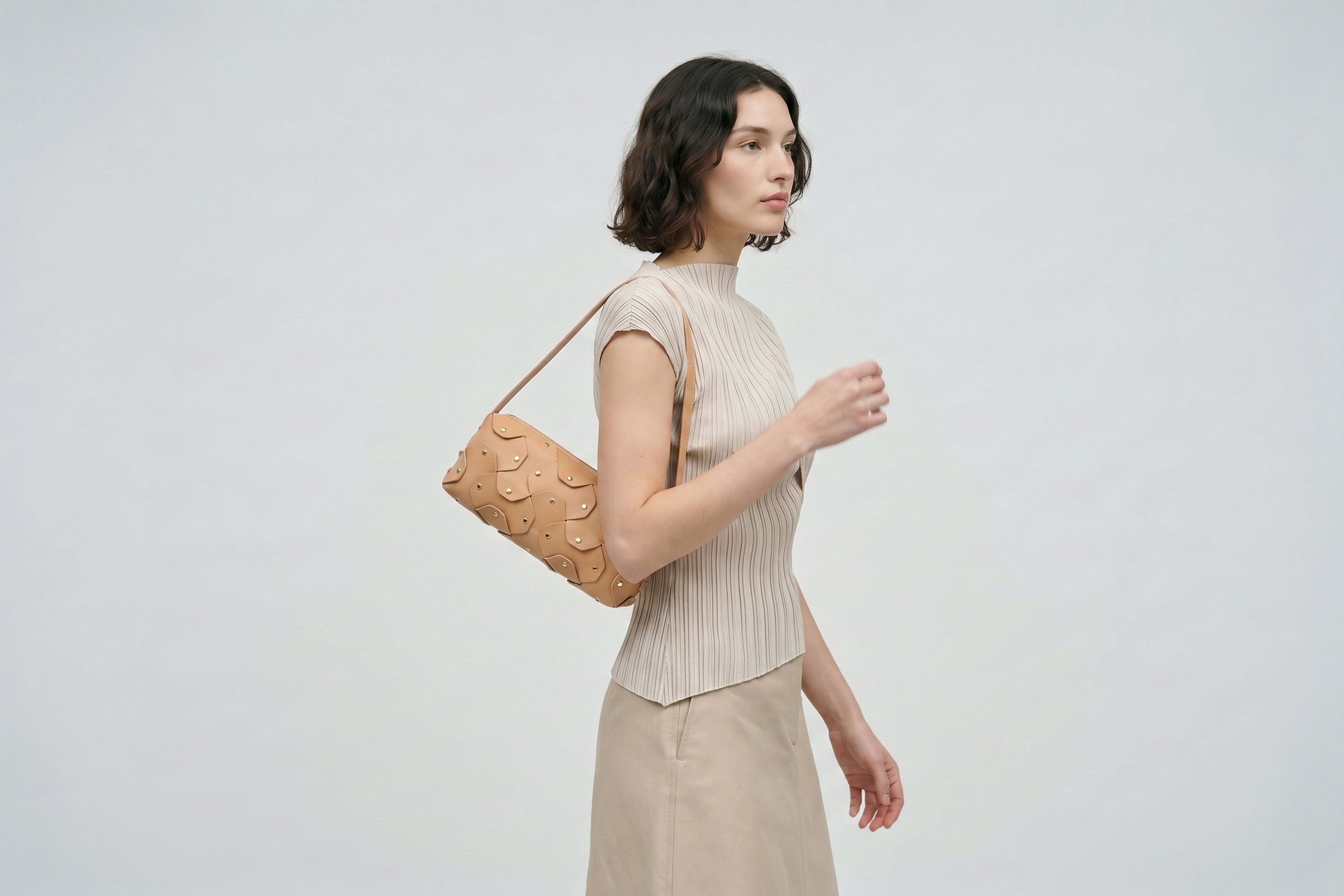 Rivet Bag 01 In Natural Color On A Woman Model In Vegetable Tanned Leather With Brass Rivets Unique Design Atelier Madre Manuel Dreesmann Barcelona Spain