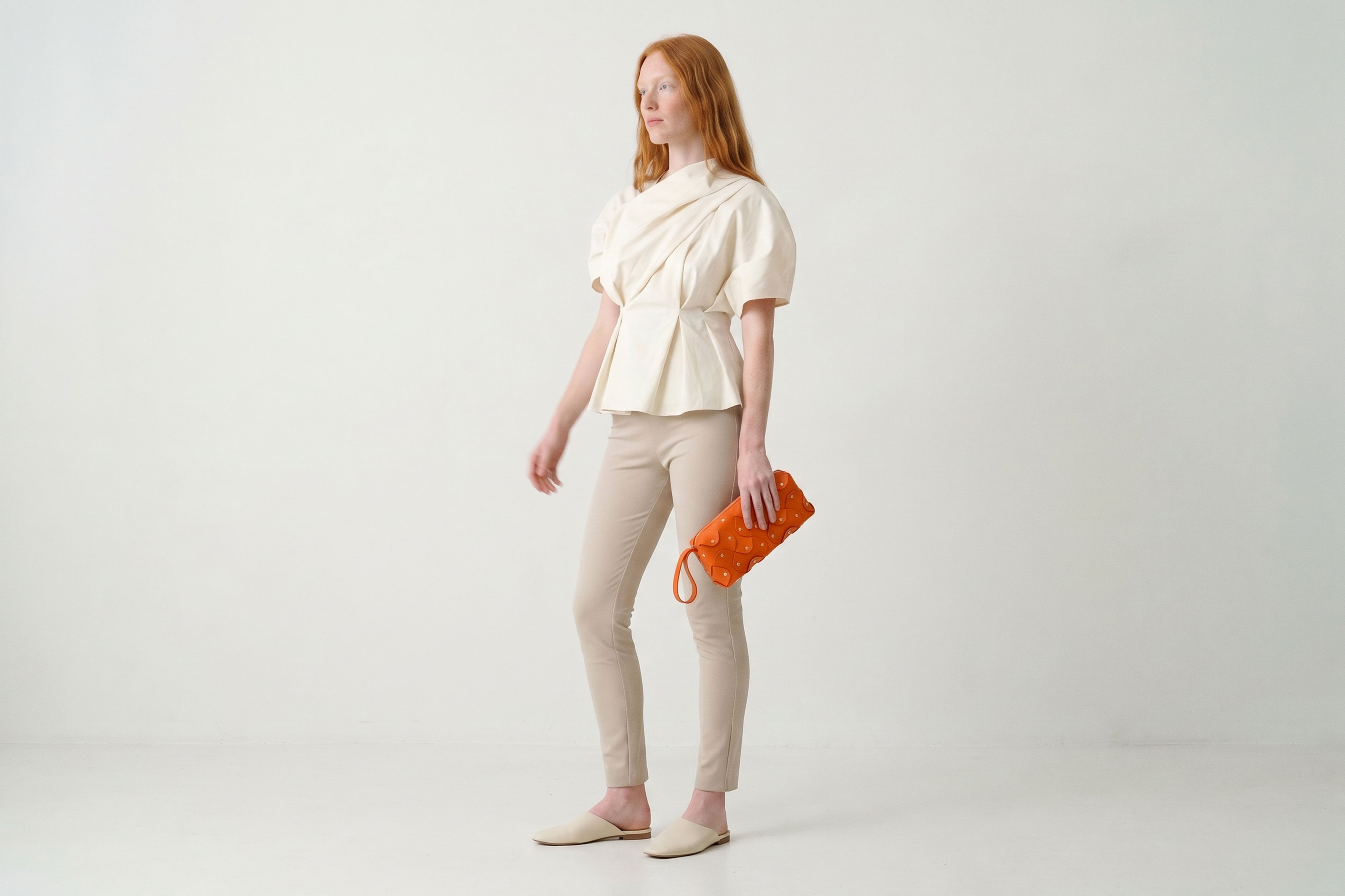 Rivet Bag 01 In Orange Color On A Woman Model In Vegetable Tanned Leather With Brass Rivets Unique Design Atelier Madre Manuel Dreesmann Barcelona Spain