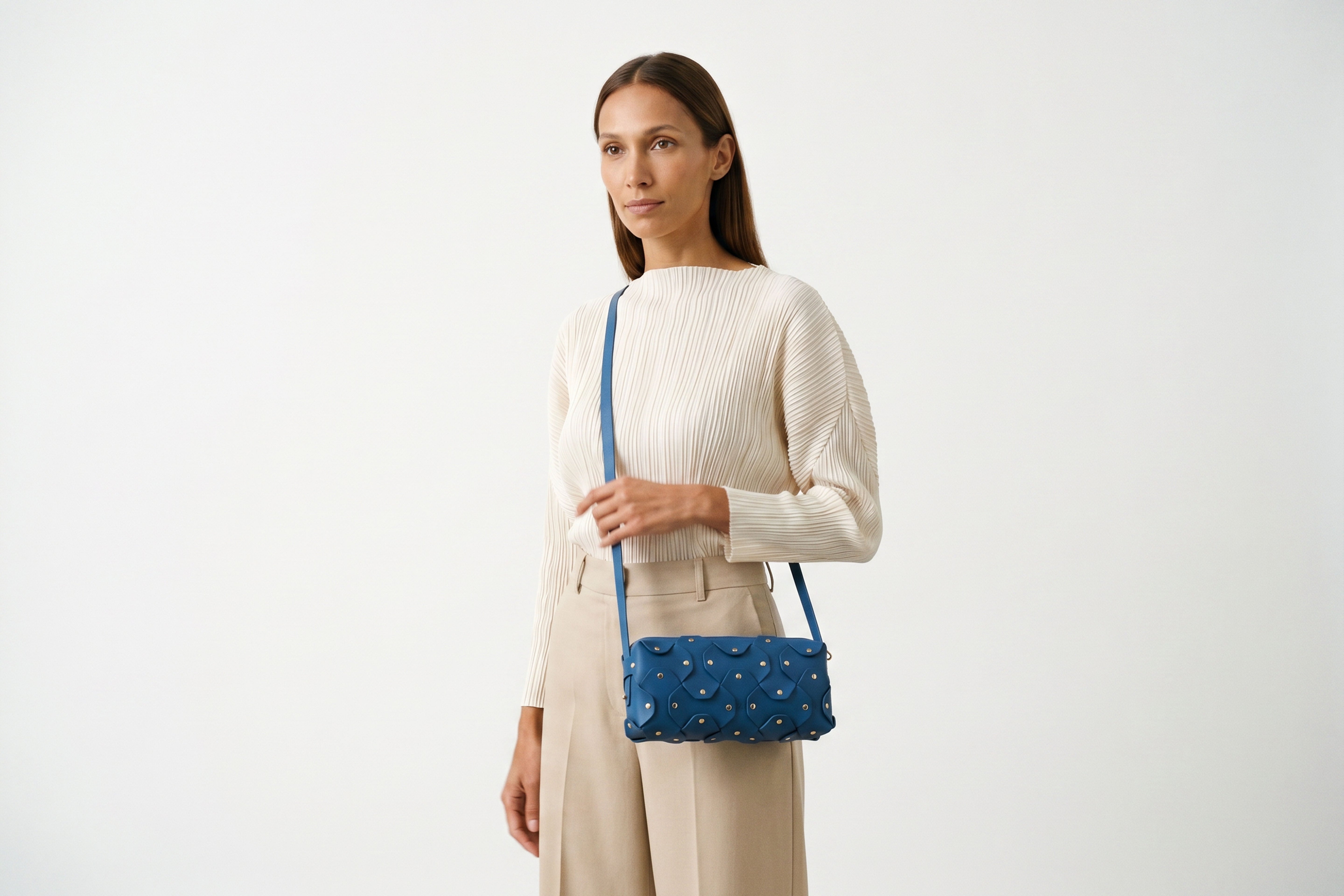 Rivet Bag 01 In Royal Blue Color On A Woman Model In Vegetable Tanned Leather With Brass Rivets Unique Design Atelier Madre Manuel Dreesmann Barcelona Spain