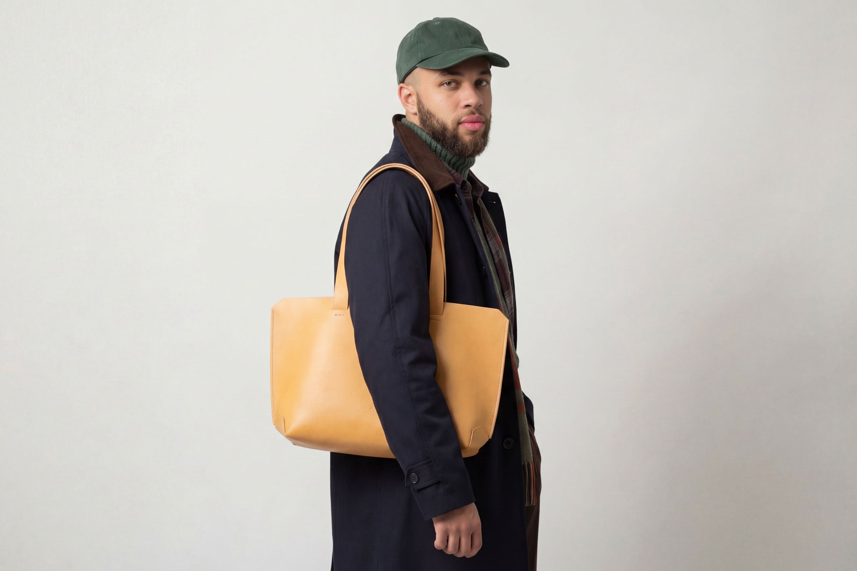 Tote Bag Leather Brown Color On A Man Model Vegetable Tanned Leather Natural Minimalistic Design By Manuel Dreesmann Atelier Madre Barcelona Spain