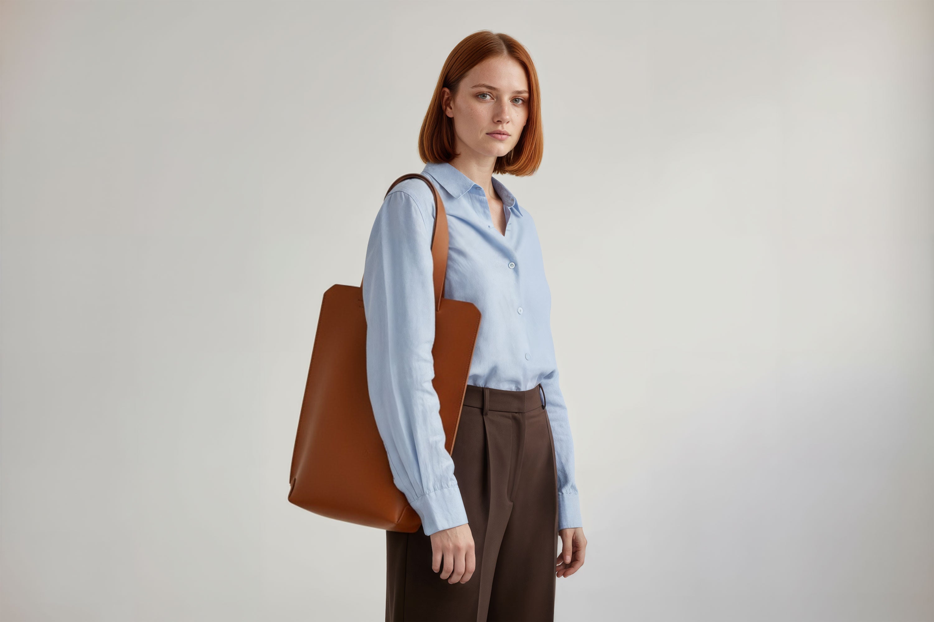 Tote Bag Long Dark Brown Color Leather Bag On A Woman Model Vegetable Tanned Leather Exclusive Quality Craftsmanship Handmade Design By Manuel Dreesmann Atelier Madre Barcelona Spain