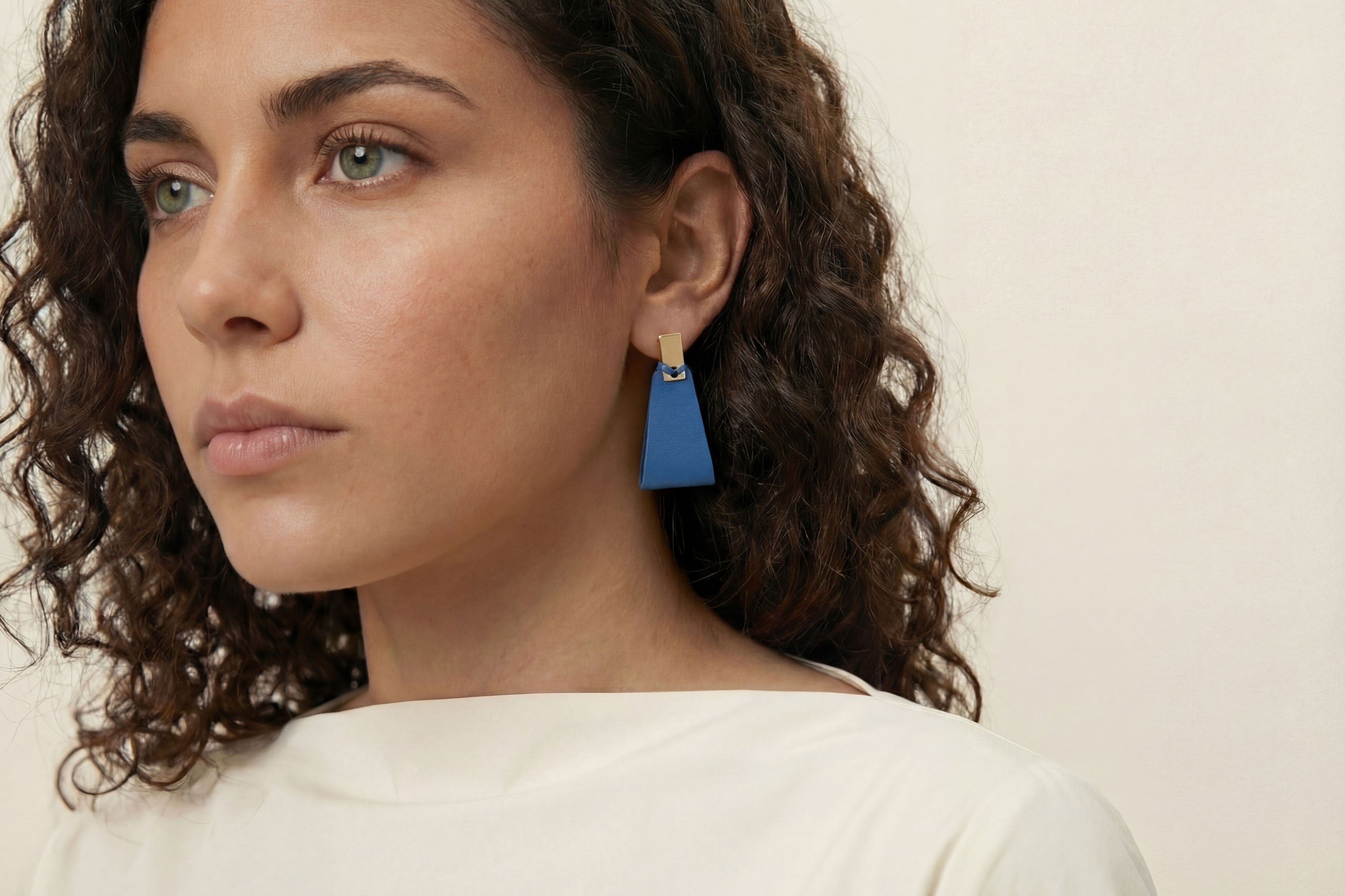 Valeria Earrings In Royal Blue Color On Model Vegetable Tanned Leather Geometric Minimalistic Design Atelier Madre Manuel Dreesmann Barcelona Spain