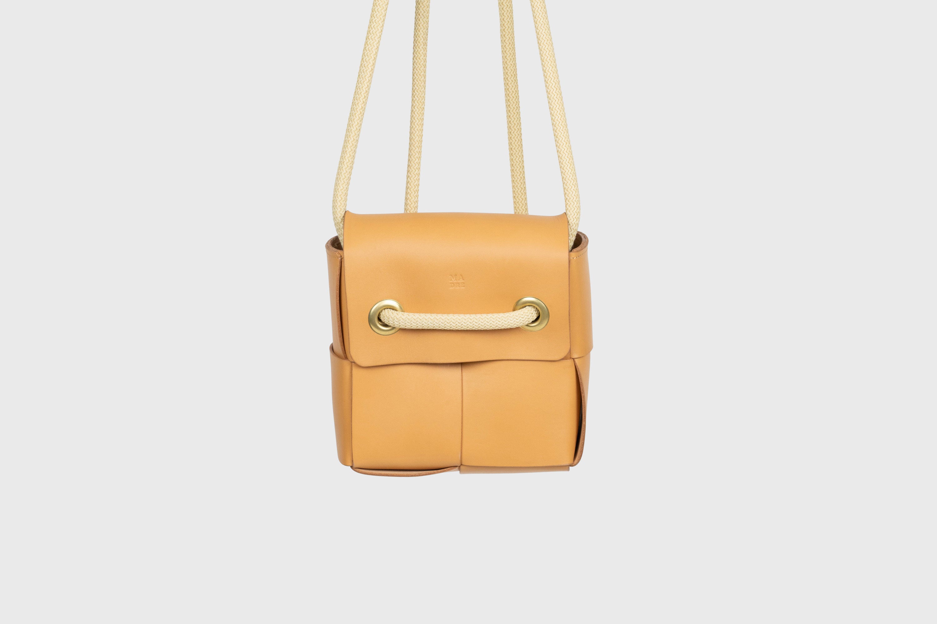 Elegant Atelier Madre Brown Color woven leather backpack, designed by Manuel Dreesmann, showcasing exquisite craftsmanship and luxury style, crafted in the heart of Barcelona.