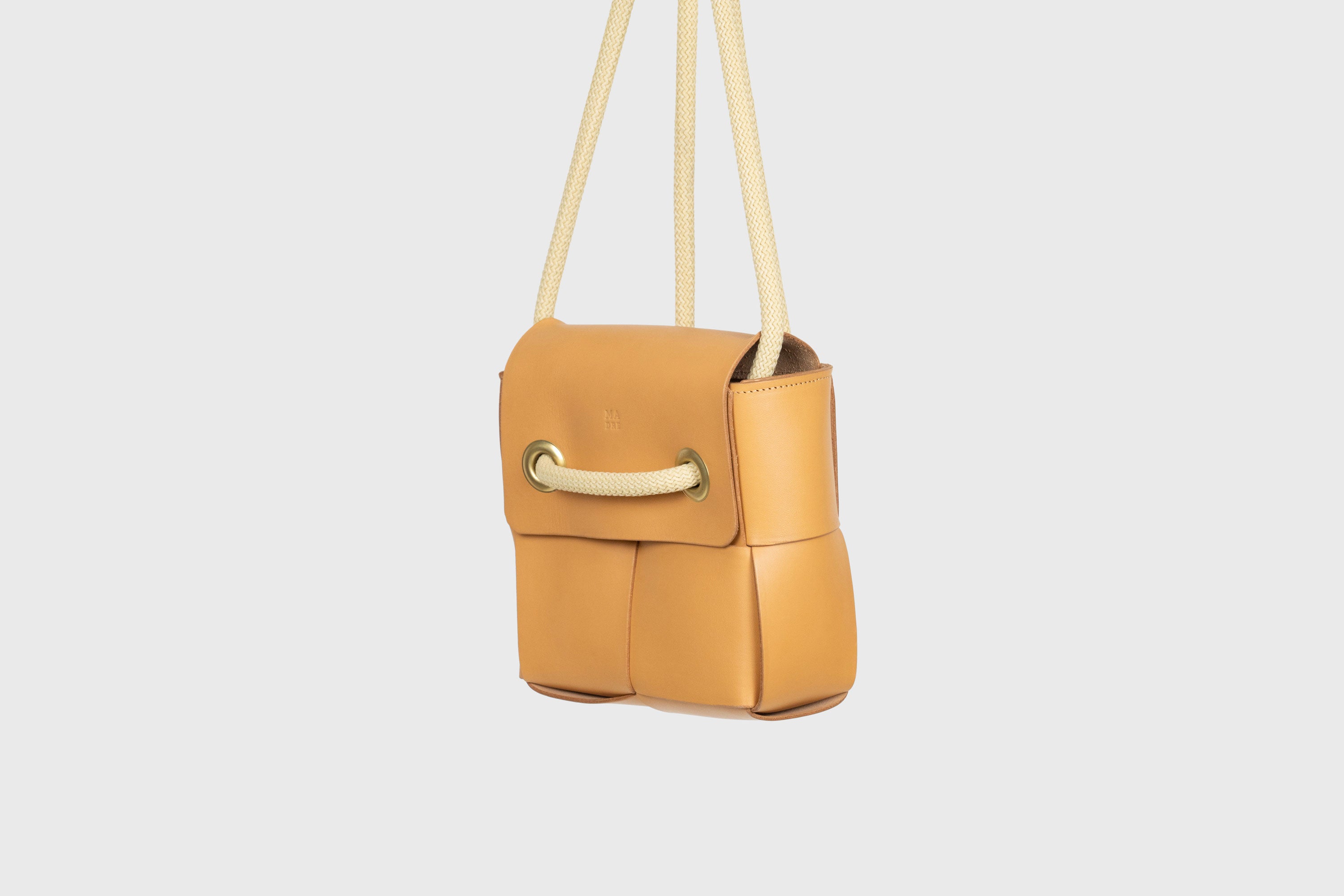 Elegant Atelier Madre Brown Color woven leather backpack, designed by Manuel Dreesmann, showcasing exquisite craftsmanship and luxury style, crafted in the heart of Barcelona.