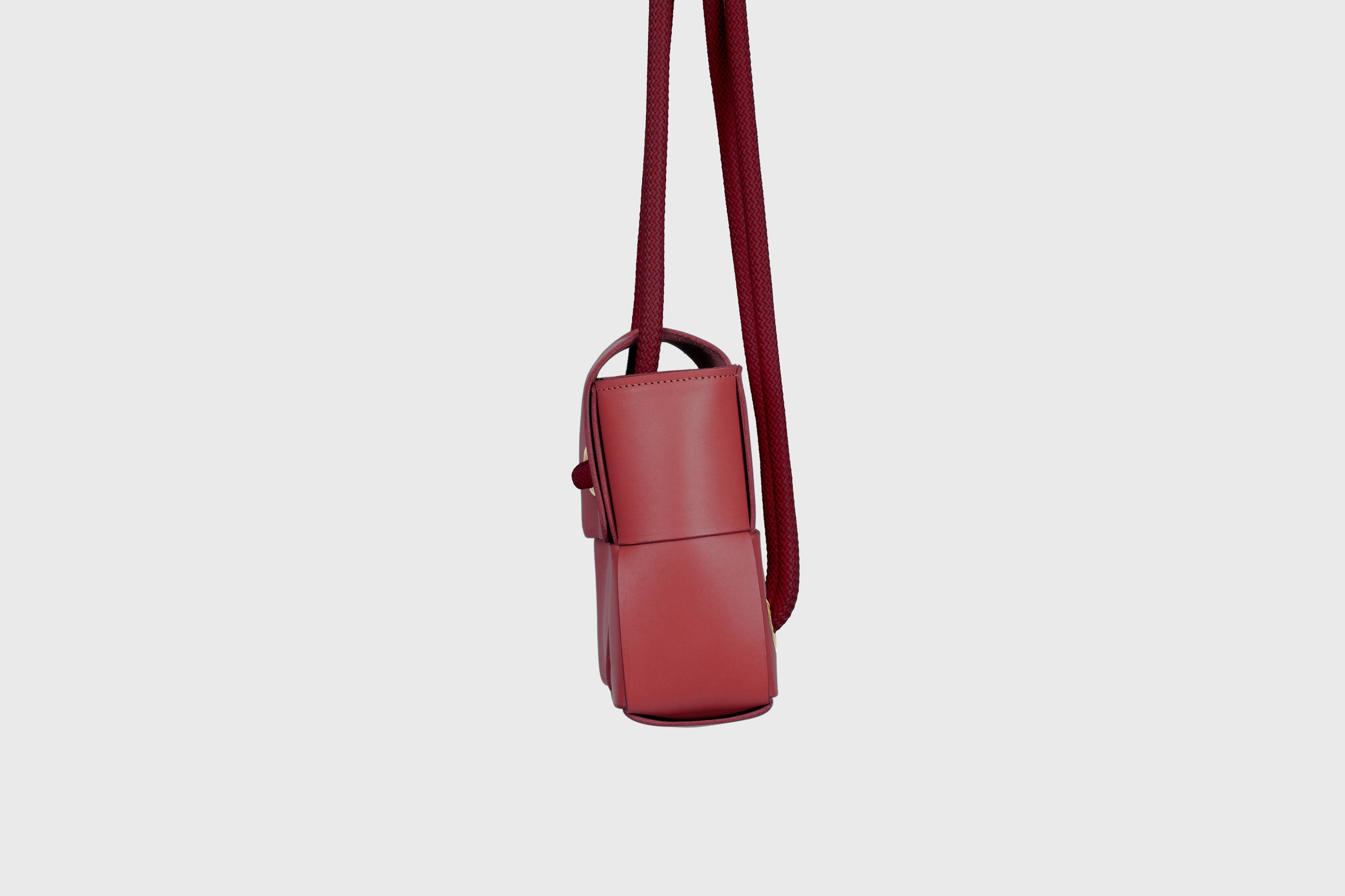 Elegant Atelier Madre Red Color woven leather backpack, designed by Manuel Dreesmann, showcasing exquisite craftsmanship and luxury style, crafted in the heart of Barcelona.