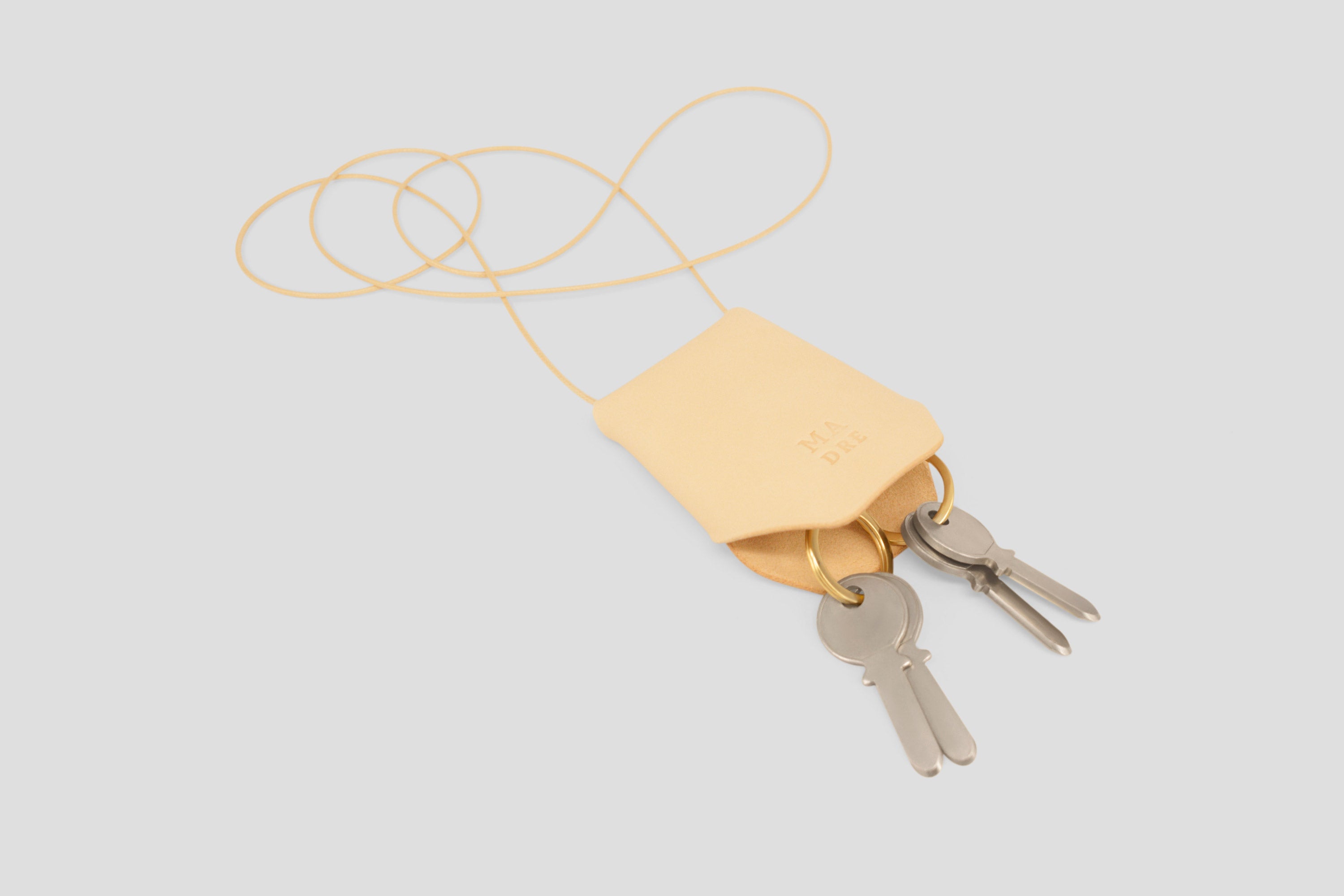 Keyhanger natural color pouch leather clochette made out of vegetable tanned leather designed by atelier madre manuel dreesmann barcelona