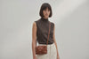 Rivet Bag Small Leather Dark Brown Color Clutch On Model Video Loop Walk Crossbody Shoulder Detachable Full Brass Vegetable Tanned Full Grain Leather High Quality Modern Minimalistic Design Atelier Madre Manuel Dreesmann Barcelona Spain