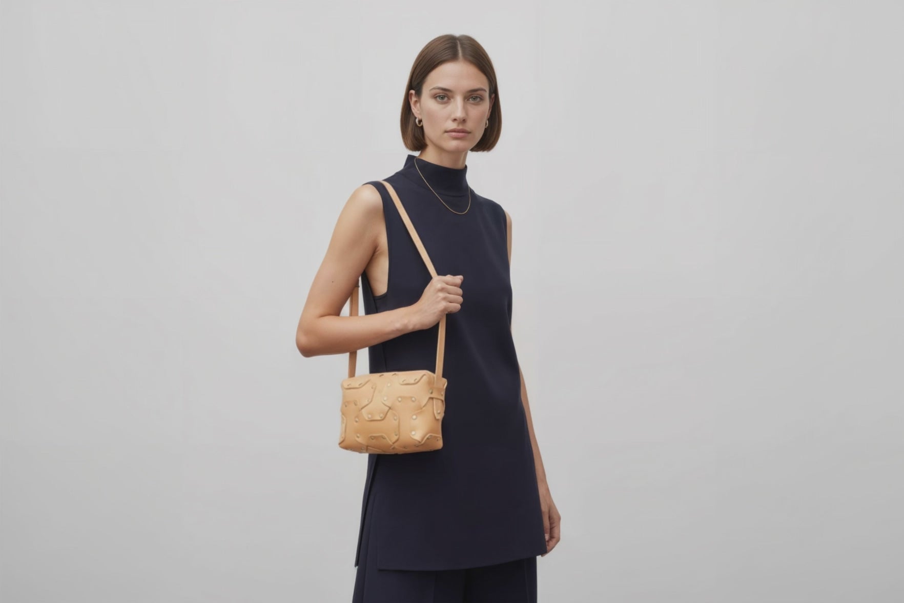 Double Rivet Bag Natural Color On A Woman Model Leather Full Grain Vegetable Tanned Leather Modern Minimalist Design Premium Quality Full Brass Clutch Crossbody Shoulder Bag Atelier Madre Manuel Dreesmann Barcelona Spain