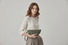 Juno Leather Bag Olive Green Color  On A Model Vegetable Tanned Full Grain Spain Brass Rivets Design Minimalist Half Moon Circle Round Zipper Pouch Handbag Clutch Bag Atelier Madre Manuel Dreesmann Barcelona