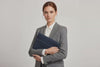 Model is holding a leather sleeve for a MacBook in marine blue color in front of bright background Video Loop minimalistic design atelier Madre Manuel Dreesmann Barcelona Spain