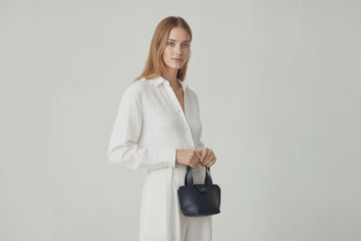 Mini Tote Bag Marine Blue Color Leather Handbag On A Woman Model Small Modern Minimalist Design Premium Quality Atelier Madre Manuel Dreesmann Barcelona Spain