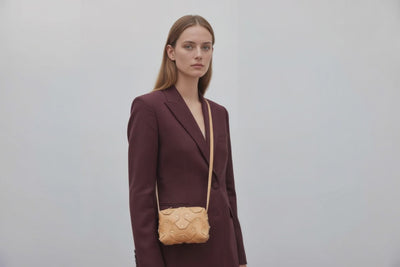 Rivet Bag Small Leather Natural Color On A Woman Model Clutch Crossbody Shoulder Detachable Full Brass Vegetable Tanned Full Grain Leather High Quality Modern Minimalistic Design Atelier Madre Manuel Dreesmann Barcelona Spain