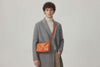 Woven Leather Bag Saka Bag Orange Color Leather On Man Model Bright Background Vegetable Tanned Leather Modern Minimalist Design Premium Quality Atelier Madre Manuel Dreesmann Barcelona Spain Video Loop