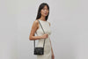 Rivet Bag Small Leather Black Color Clutch Crossbody Shoulder On Model Video Loop Walk Detachable Full Brass Vegetable Tanned Full Grain Leather High Quality Modern Minimalistic Design Atelier Madre Manuel Dreesmann Barcelona Spain