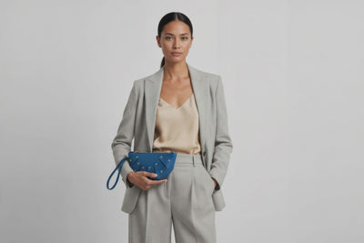 Juno Leather Bag Royal Blue Color On A Model Vegetable Tanned Full Grain Spain Brass Rivets Design Minimalist Half Moon Circle Round Zipper Pouch Handbag Clutch Bag Atelier Madre Manuel Dreesmann Barcelona