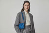 Woven Leather Bag Saka Bag Royal Blue Color Leather On Woman Model Bright Background Vegetable Tanned Leather Modern Minimalist Design Premium Quality Atelier Madre Manuel Dreesmann Barcelona Spain Video Loop