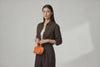 Nano Leather Tote Bag Orange Color On A Woman Model Premium Quality Minimalist Design Atelier Madre Manuel Dreesmann Barcelona Spain