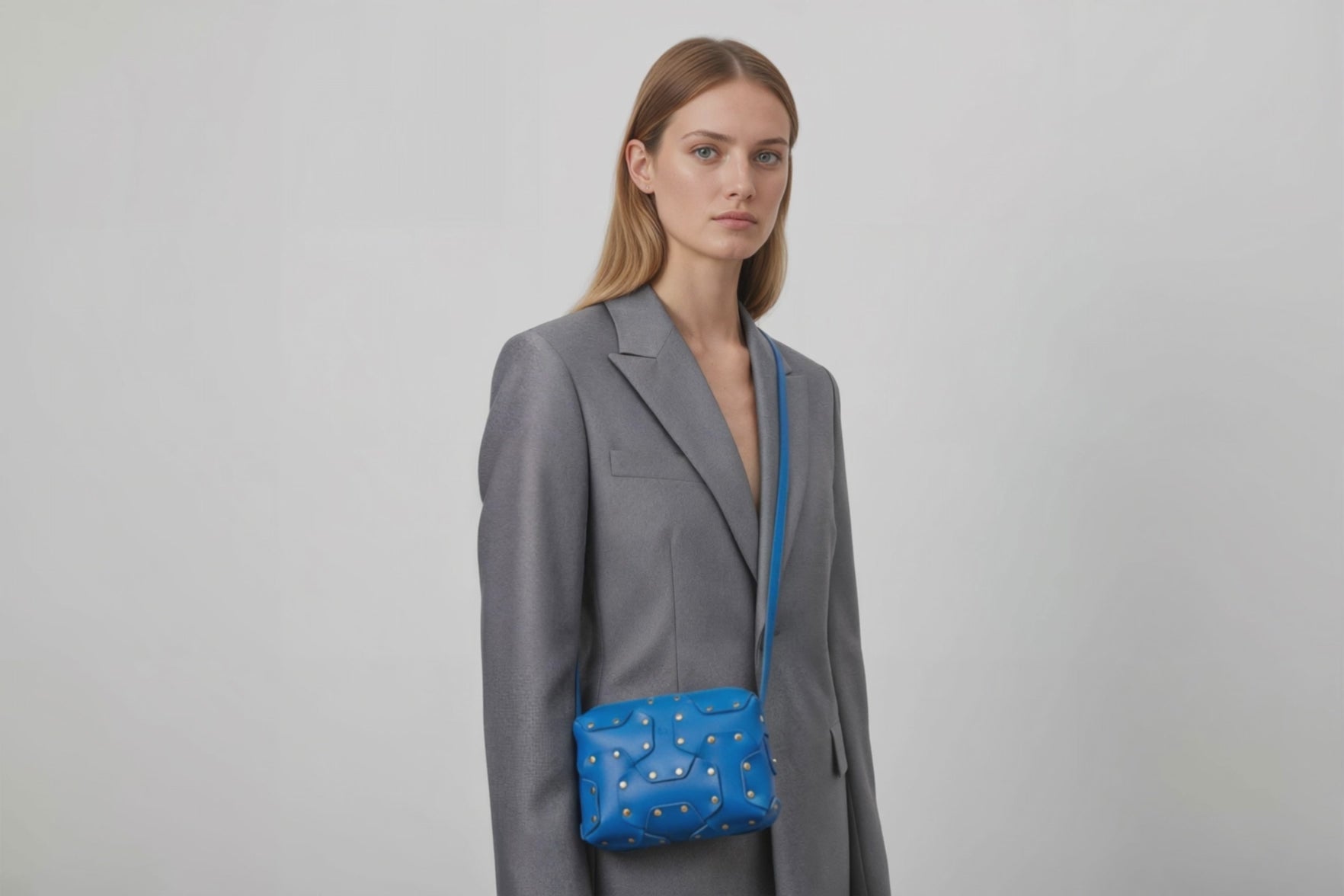 Double Rivet Bag Royal Blue Color On A Woman Model Leather Full Grain Vegetable Tanned Leather Modern Minimalist Design Premium Quality Full Brass Clutch Crossbody Shoulder Bag Atelier Madre Manuel Dreesmann Barcelona Spain