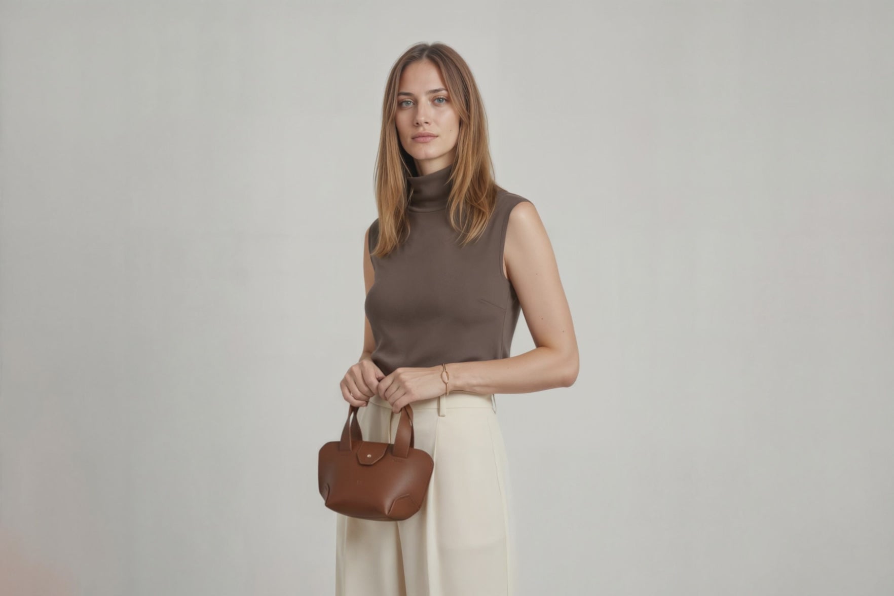 Mini Tote Bag Dark Brown Color Leather Handbag On A Woman Model Small Modern Minimalist Design Premium Quality Atelier Madre Manuel Dreesmann Barcelona Spain