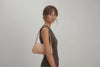 Fiona Bag Natural Color Leather On Model Bright Background Vegetable Tanned Leather Video Loop Walking Modern Minimalist Design Premium Quality Atelier Madre Manuel Dreesmann Barcelona Spain