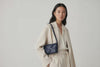 Woven Leather Bag Saka Bag Marine Blue Color Leather On Woman Model Bright Background Vegetable Tanned Leather Modern Minimalist Design Premium Quality Atelier Madre Manuel Dreesmann Barcelona Spain Video Loop
