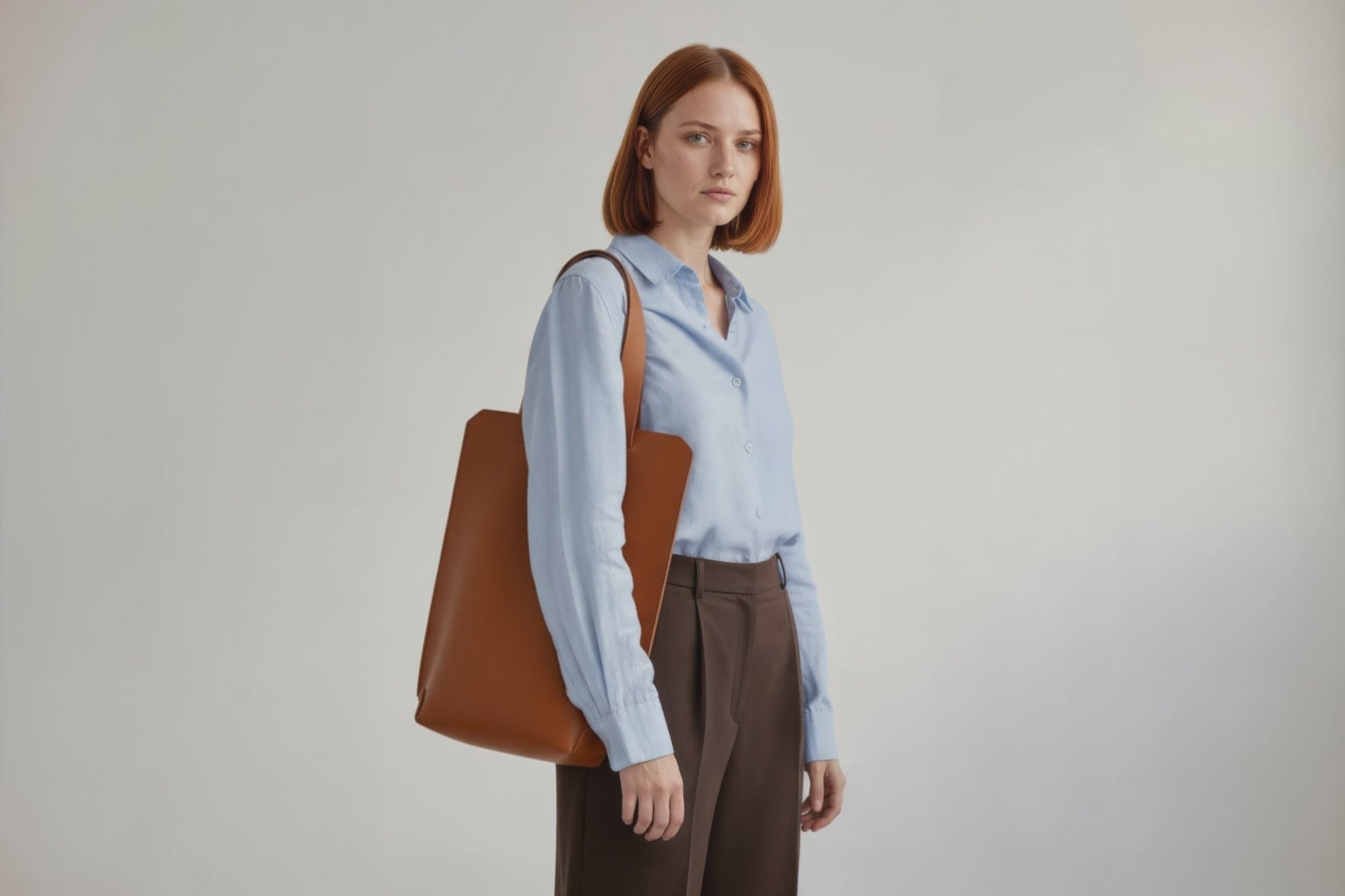 Tote Bag Long Dark Brown Color Leather Bag On A Woman Model Vegetable Tanned Leather Exclusive Quality Craftsmanship Handmade Design By Manuel Dreesmann Atelier Madre Barcelona Spain