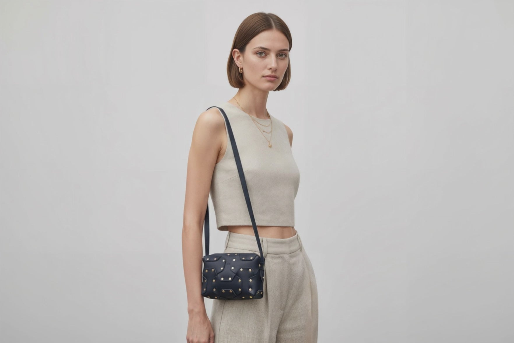 Double Rivet Bag Blue Color On A Woman Model Leather Full Grain Vegetable Tanned Leather Modern Minimalist Design Premium Quality Full Brass Clutch Crossbody Shoulder Bag Atelier Madre Manuel Dreesmann Barcelona Spain