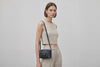 Double Rivet Bag Blue Color On A Woman Model Leather Full Grain Vegetable Tanned Leather Modern Minimalist Design Premium Quality Full Brass Clutch Crossbody Shoulder Bag Atelier Madre Manuel Dreesmann Barcelona Spain