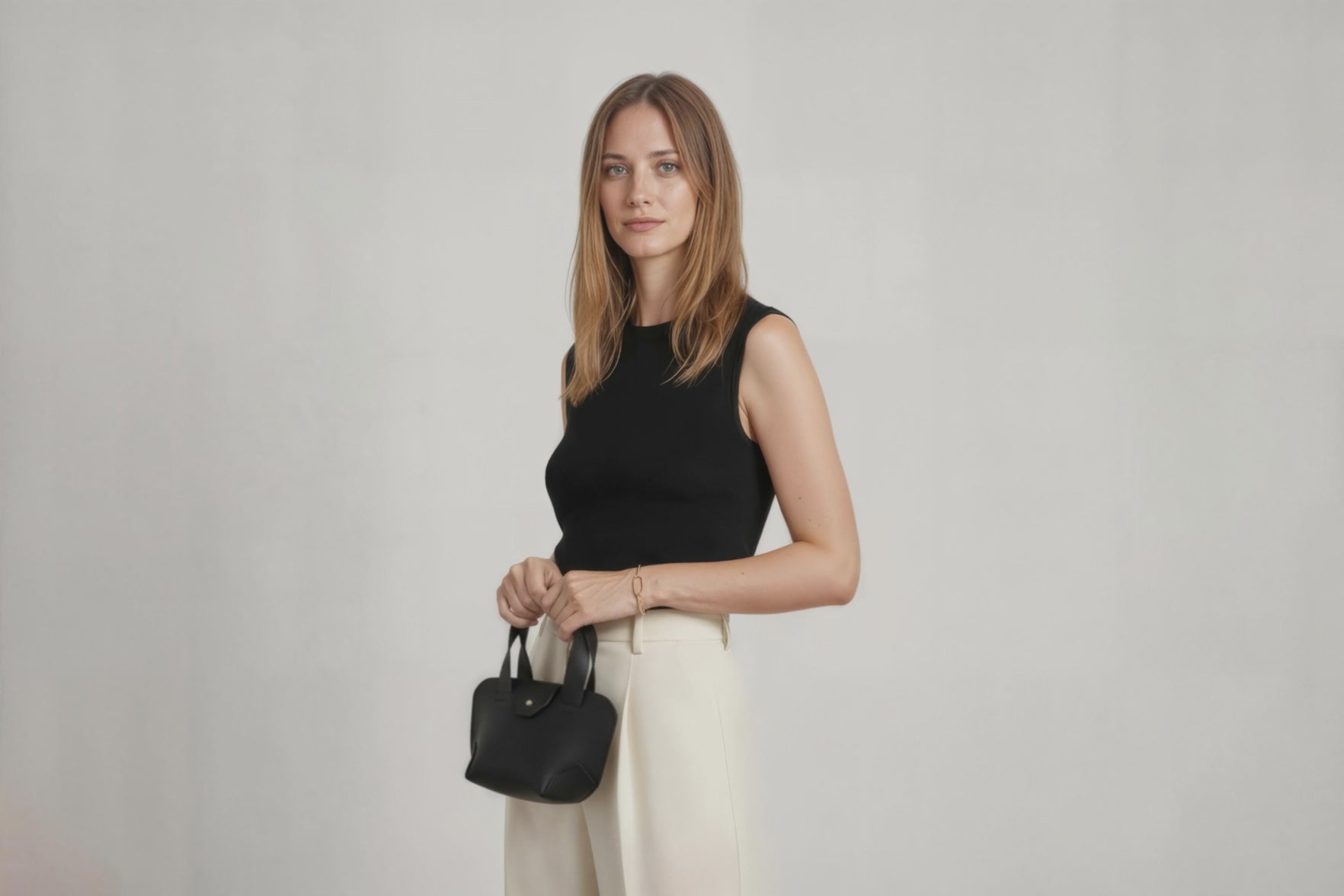 Mini Tote Bag Black Color Leather On A Woman Model Handbag Small Modern Minimalist Design Premium Quality Atelier Madre Manuel Dreesmann Barcelona Spain