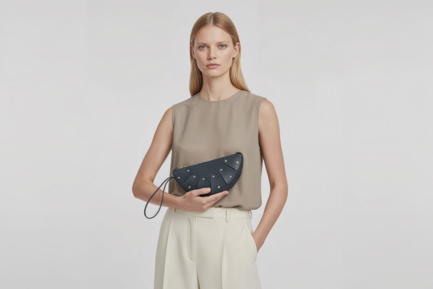 Juno Leather Bag Marine Blue Color On A Model Vegetable Tanned Full Grain Spain Brass Rivets Design Minimalist Half Moon Circle Round Zipper Pouch Handbag Clutch Bag Atelier Madre Manuel Dreesmann Barcelona