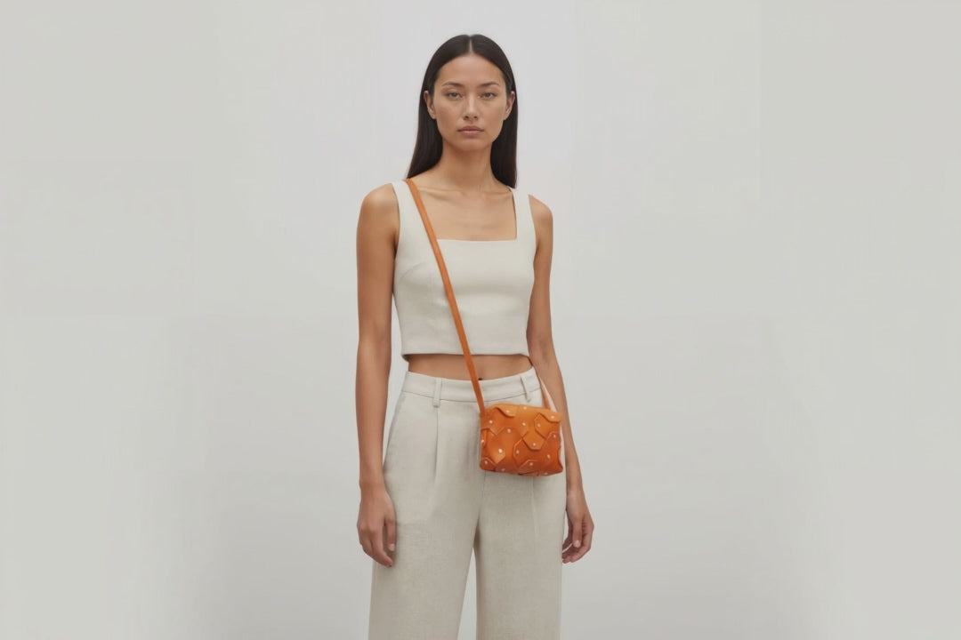 Rivet Bag Small Leather Orange Color Clutch Crossbody On Model Video Loop Walk Shoulder Detachable Full Brass Vegetable Tanned Full Grain Leather High Quality Modern Minimalistic Design Atelier Madre Manuel Dreesmann Barcelona Spain