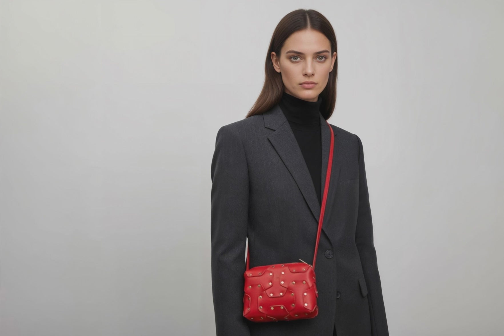 Double Rivet Bag Red Color On A Woman Model Leather Full Grain Vegetable Tanned Leather Modern Minimalist Design Premium Quality Full Brass Clutch Crossbody Shoulder Bag Atelier Madre Manuel Dreesmann Barcelona Spain