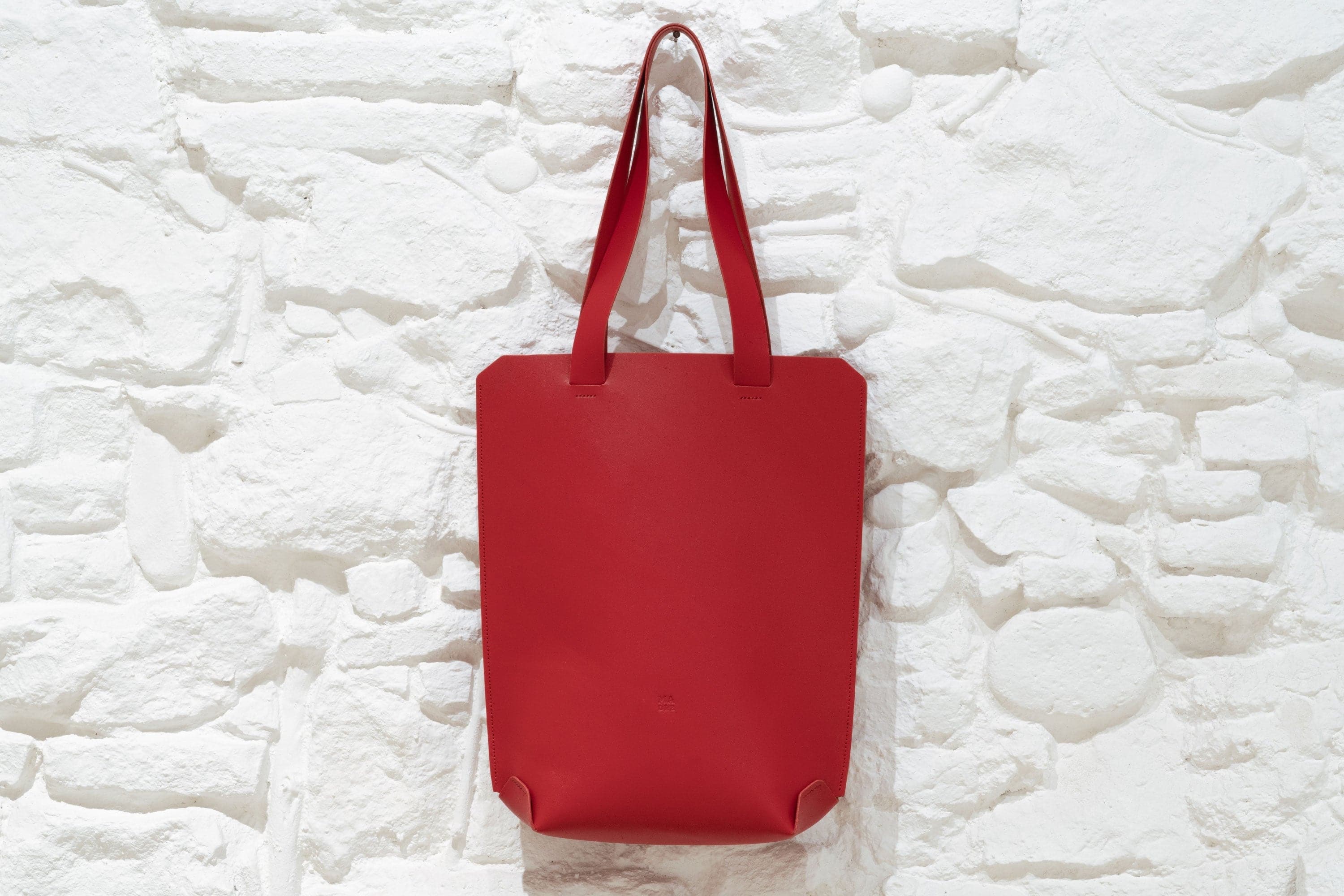 Large Tote Handbag Red Leather Vachetta Minimalistic Design Hanging on Wall Design By Manuel Dreesmann Atelier Madre Barcelona Spain