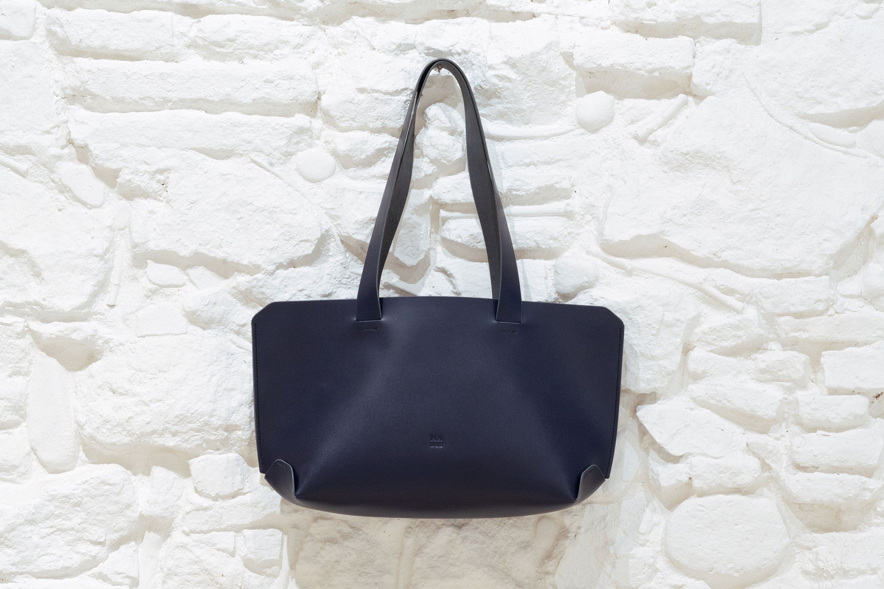 Tote Bag Marine Blue Vegetable Tanned Leather Hanging on Wall Minimal Design By Manuel Dreesmann Atelier Madre Barcelona Spain